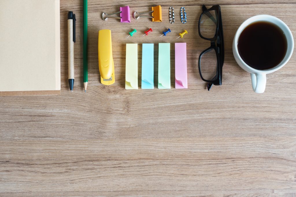 Office supplies on wooden background